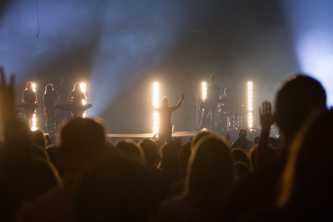 Live concert with stage lighting and an audience
